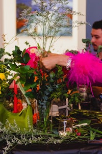 a woman putting flowers in a vase