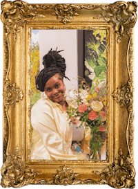 a woman holding a bouquet of flowers in a gold frame